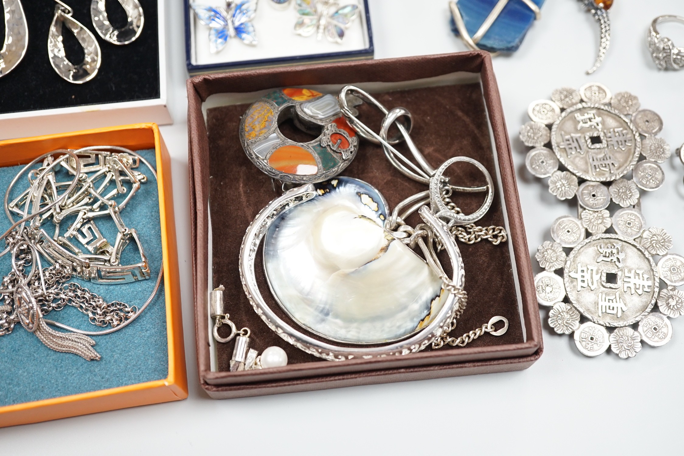 Mixed silver and white metal jewellery including a modern silver nurses buckle, an early 20th century white metal and Scottish hardstone brooch, Chinese white metal buckle by Wang Hing, etc.